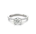 Front view of a 2 CT round cut lab grown diamond ring with a half-bezel setting and pavé band