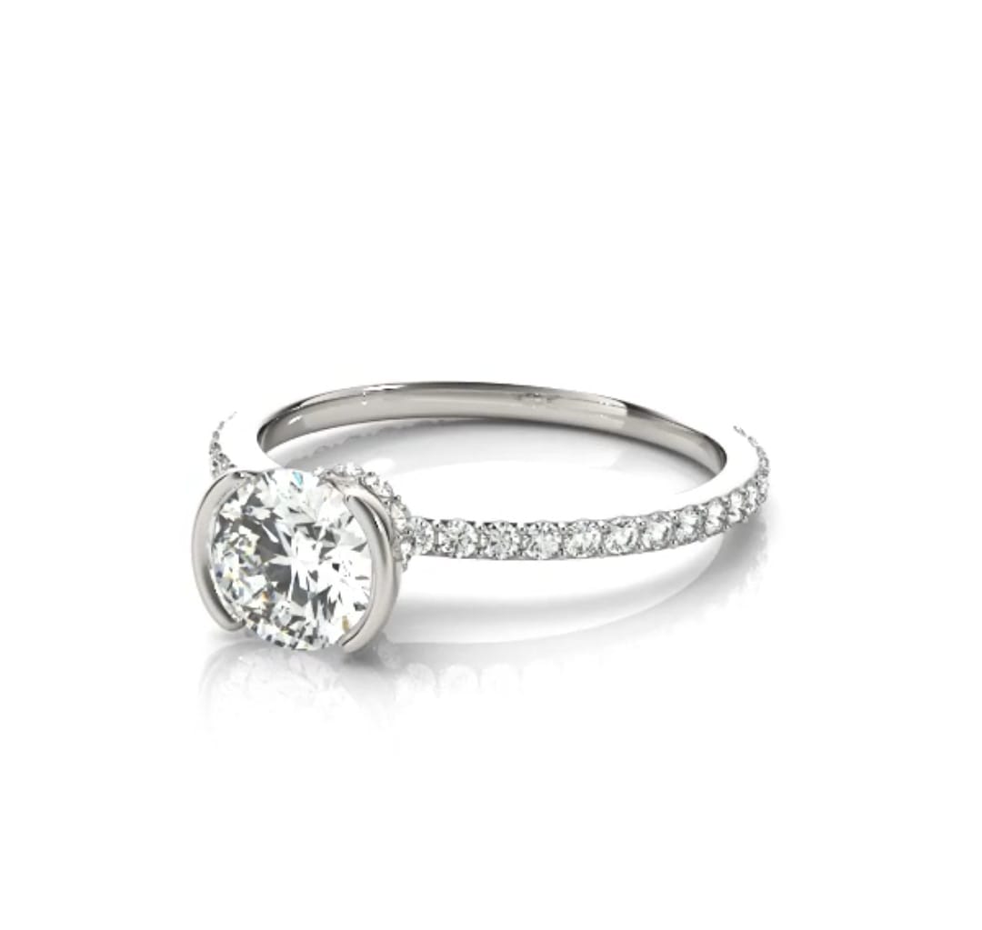Angled view showcasing the round lab diamond center stone in a white gold half-bezel setting