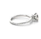 Side profile view highlighting the hidden pavé diamond halo collar underneath the center stone