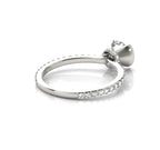Low profile side view displaying the slim pavé band and white gold half-bezel basket