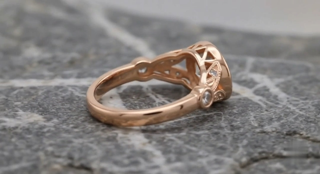 Close-up side perspective showing openwork under-gallery and side bezel accent stone on a rose gold lab diamond ring.