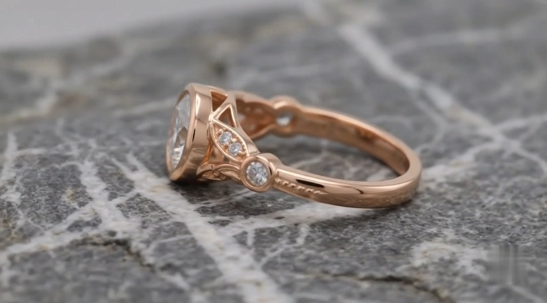 Side view showing the detailed leaf filigree pattern, fine milgrain edges, and bezel accent diamonds along the rose gold shank.