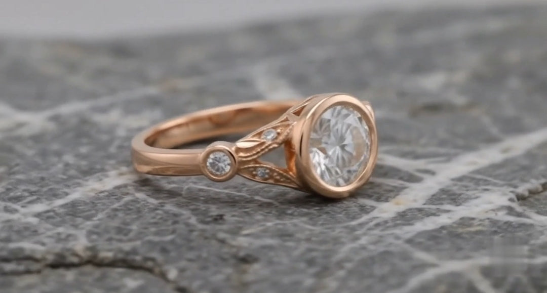 Three-quarter profile showcasing the smooth rose gold bezel frame and delicate split leaf shoulder design
