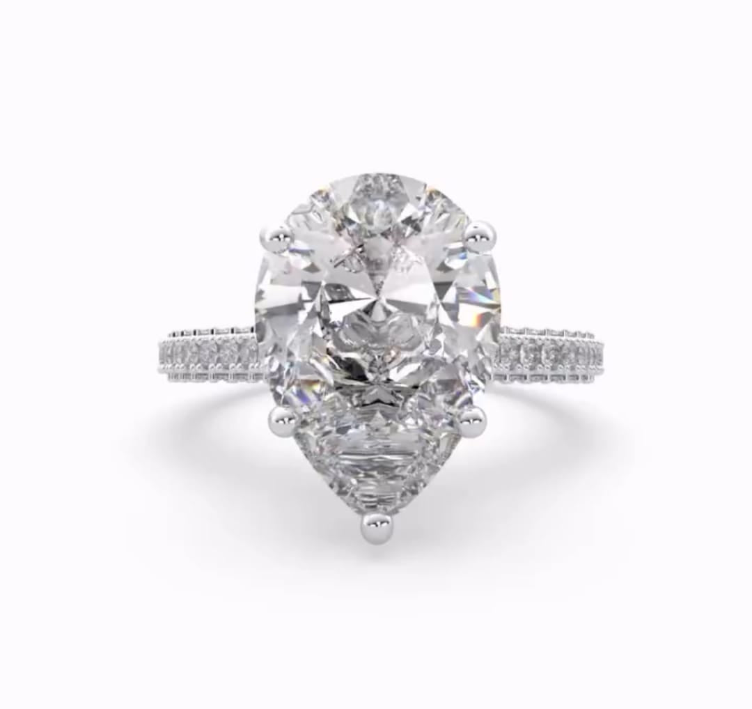 Top-down view of a 4 CT pear-cut lab-created diamond set in a white gold 5-prong setting.
