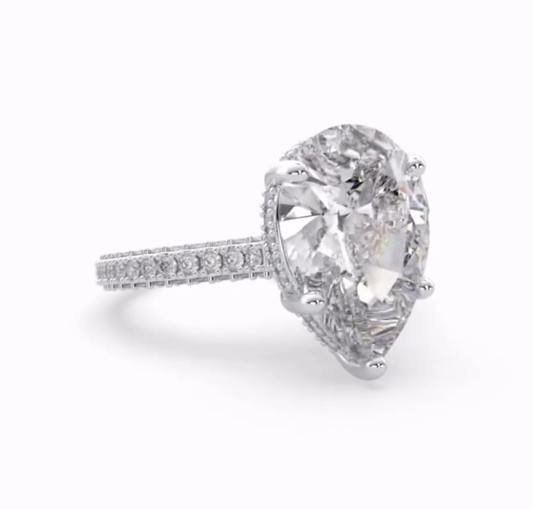 Three-quarter angle of a brilliant 4 carat pear cut lab grown diamond ring.