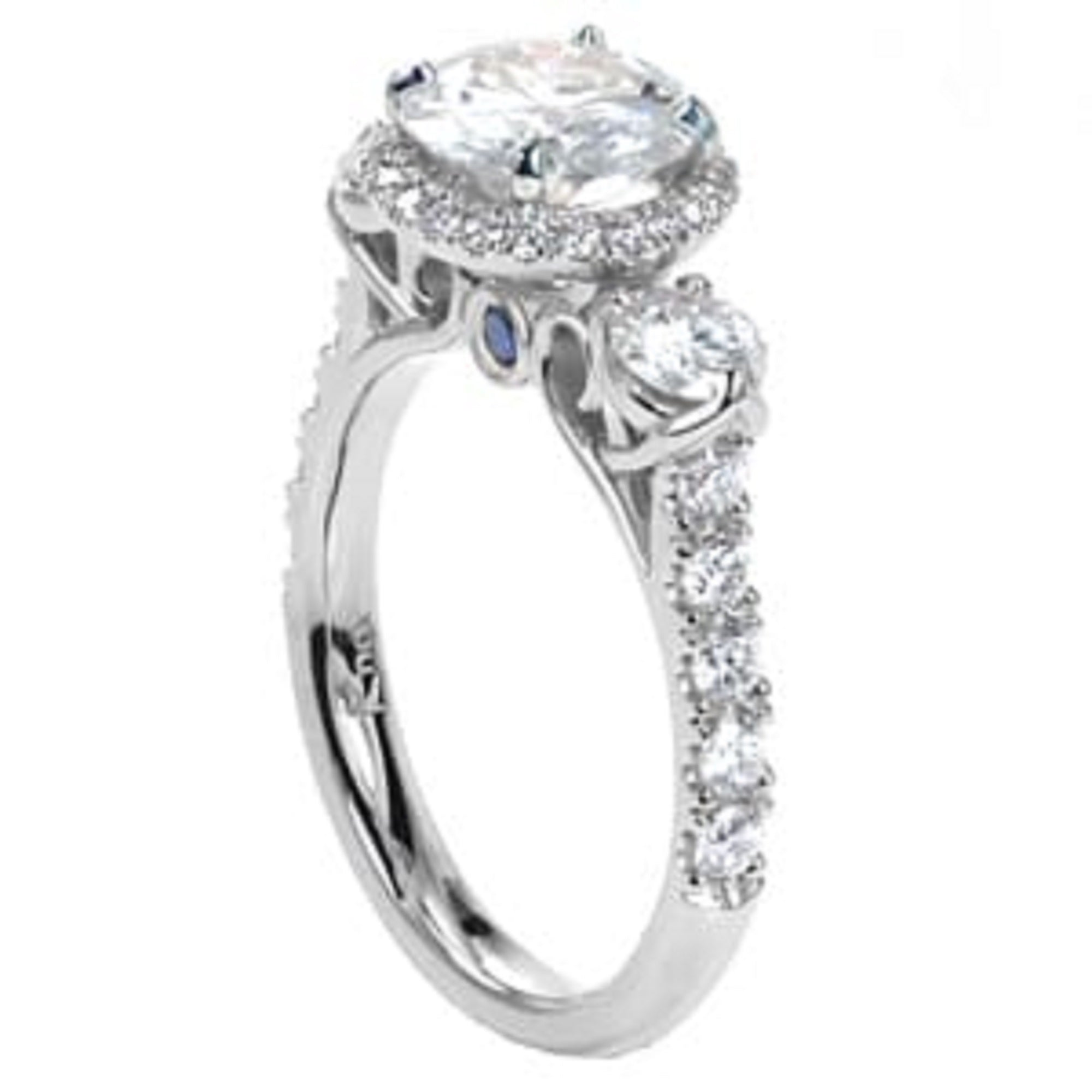 Angled side view showing the pavé band, three-stone setting, and blue sapphire accent under the gallery.