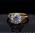 Front view of a 3 carat round cut lab grown diamond solitaire engagement ring set in polished gold.