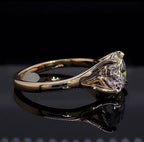 Side profile of a 3 CT round lab created diamond ring displaying the split-throat basket detail and gold band.