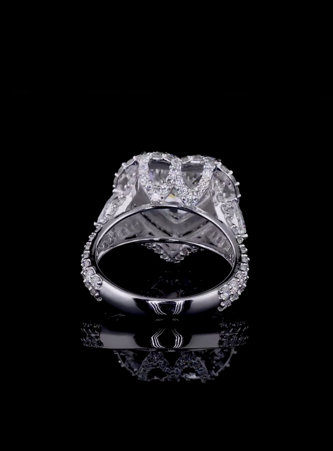 Rear gallery profile showing the ornate diamond-paved bridge and basket support of a heart solitaire halo ring.