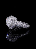 Three-quarter side view showing the pear cut side stone transitioning into the split-shank pavé band.