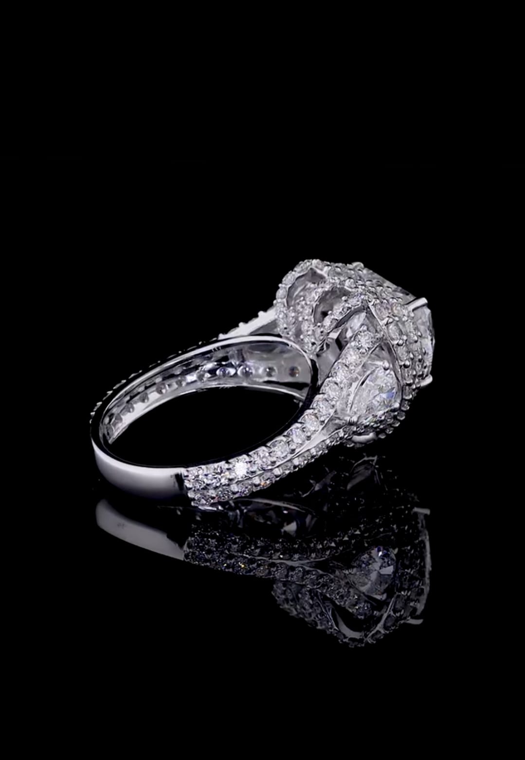 Elevated rear angle view illustrating the smooth inner band and pavé halo construction.