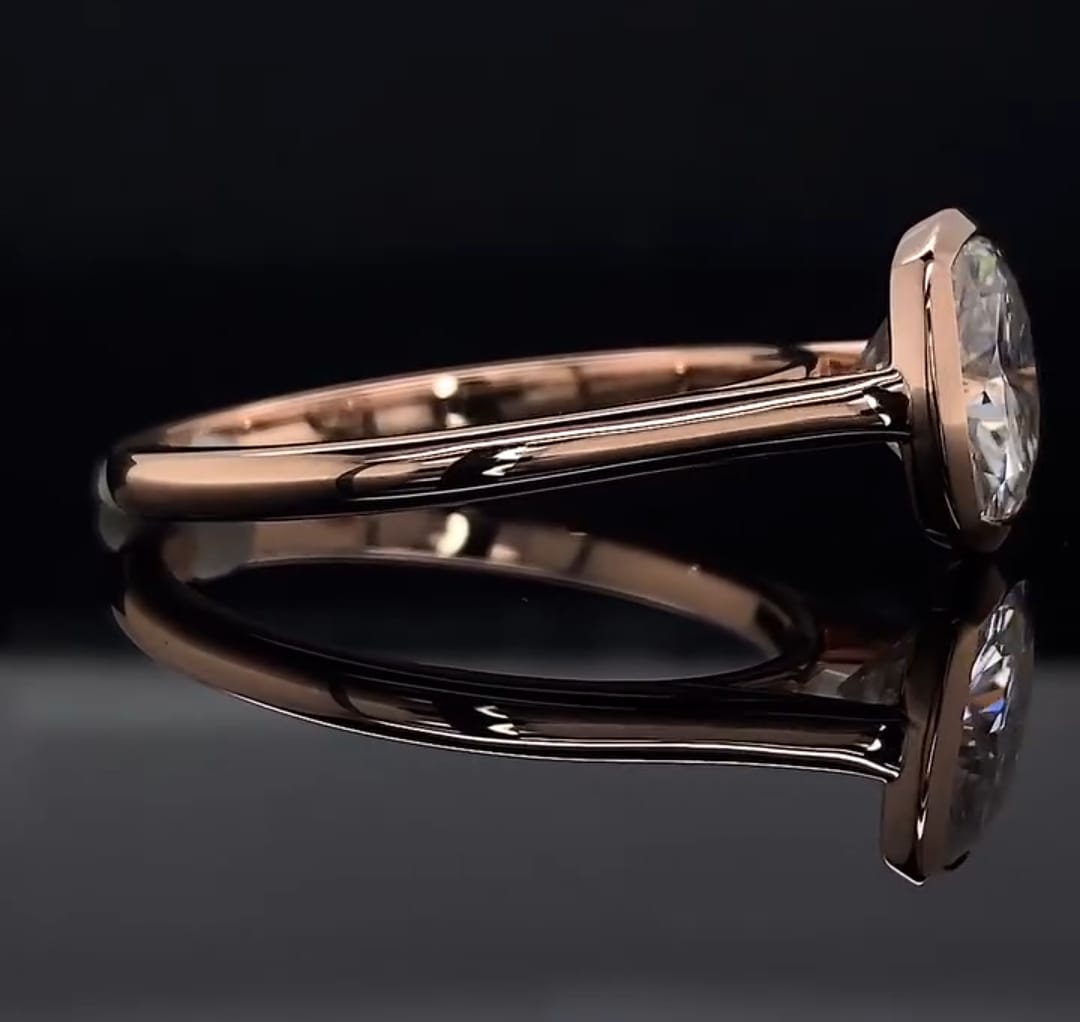 Low-profile side view highlighting the sleek bezel construction and comfort-fit gold band.