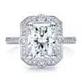 Close-up macro photograph of a 3 carat radiant cut lab grown diamond vintage milgrain halo engagement ring.