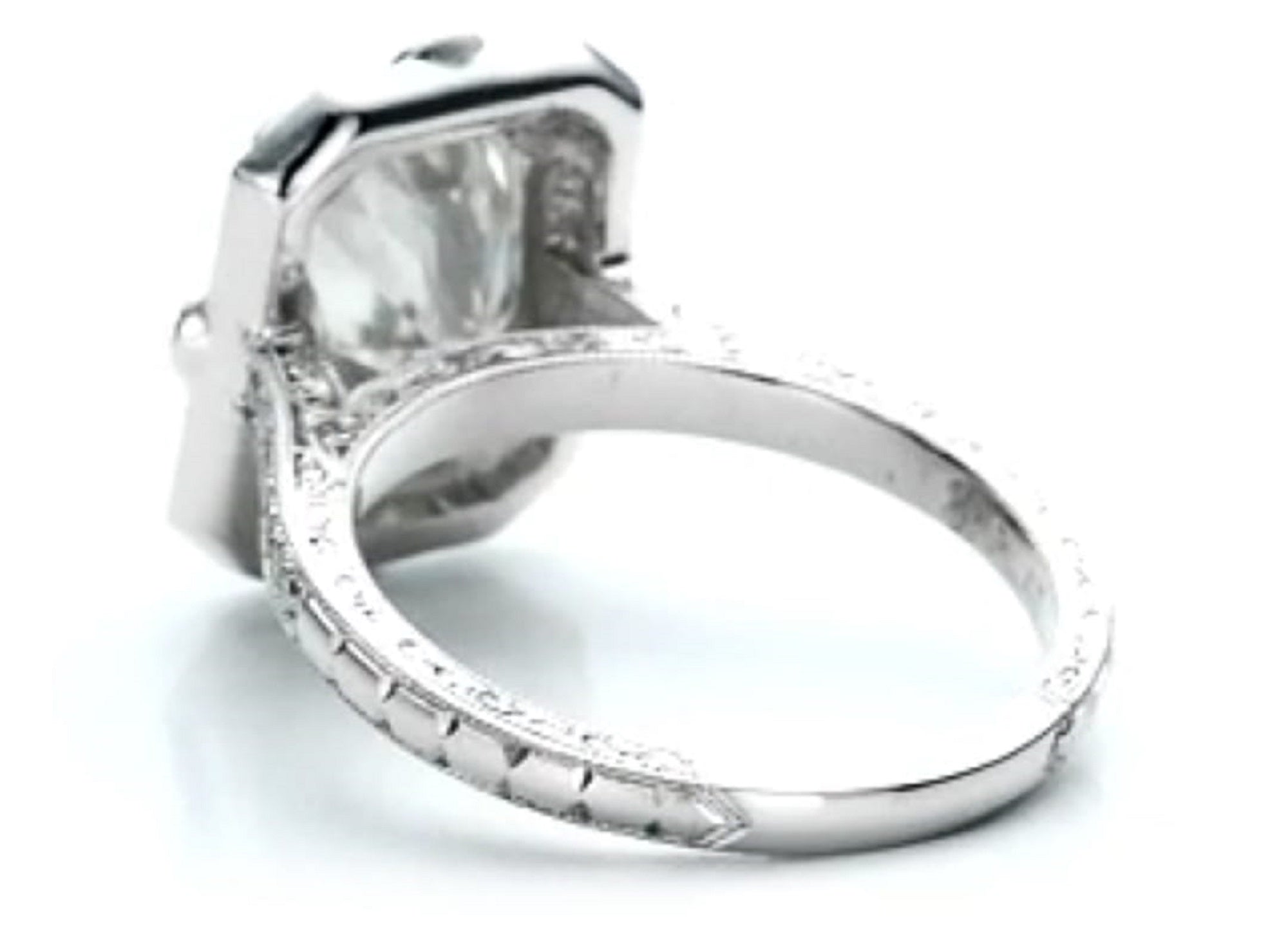 Underside view of a vintage radiant halo ring showcasing the inner platinum band and gallery support.