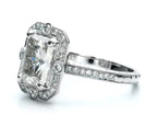 Angled front profile highlighting the raised center radiant diamond and fine milgrain halo trim.