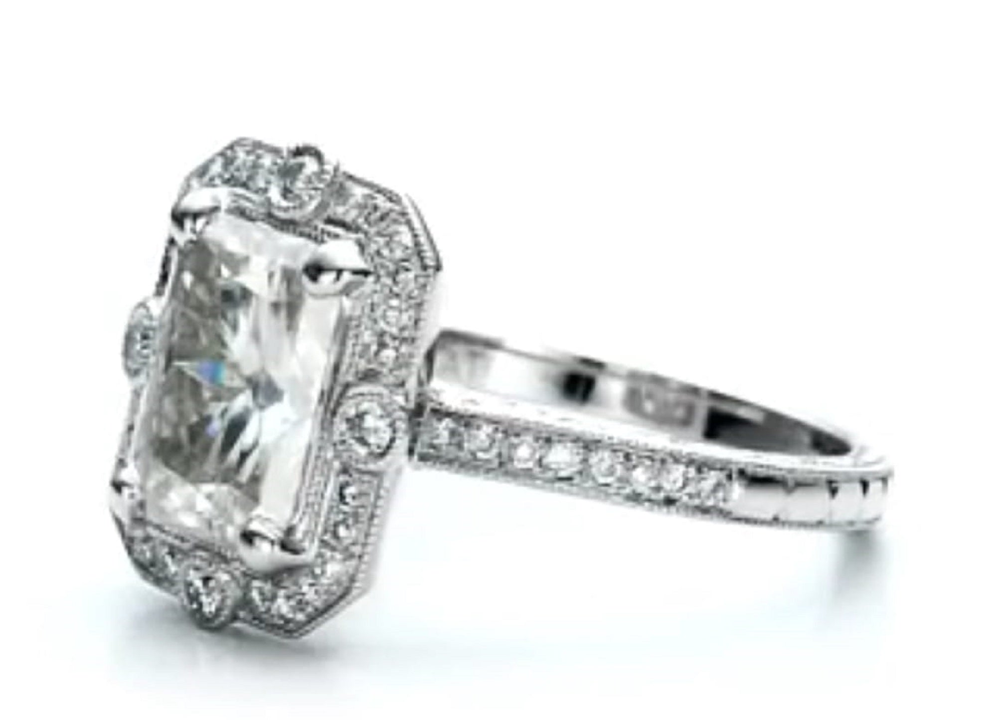 Angled front profile highlighting the raised center radiant diamond and fine milgrain halo trim.