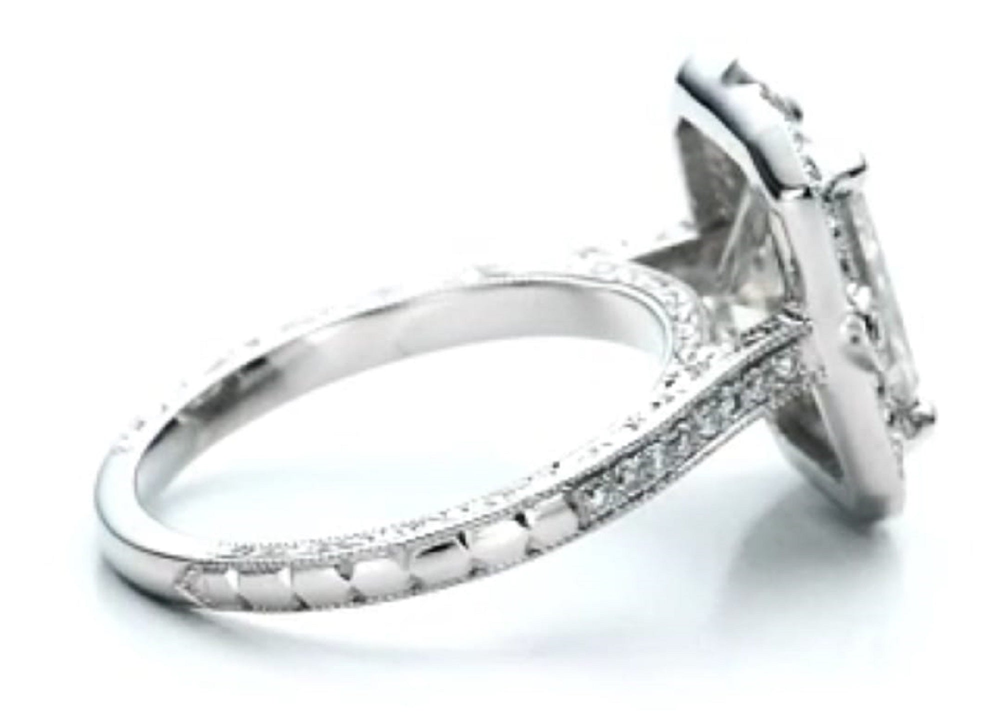 Elevated side profile view displaying the carved side shank detail and diamond basket construction.