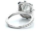 Rear perspective highlighting the hand-carved side patterns and halo basket of a vintage diamond ring