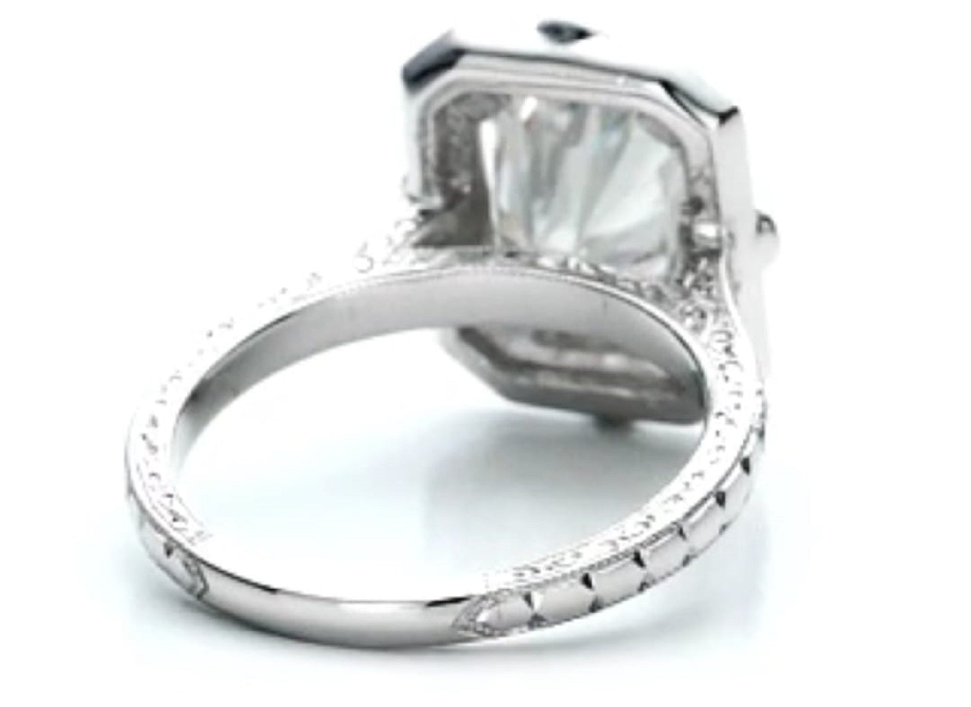 Rear perspective highlighting the hand-carved side patterns and halo basket of a vintage diamond ring