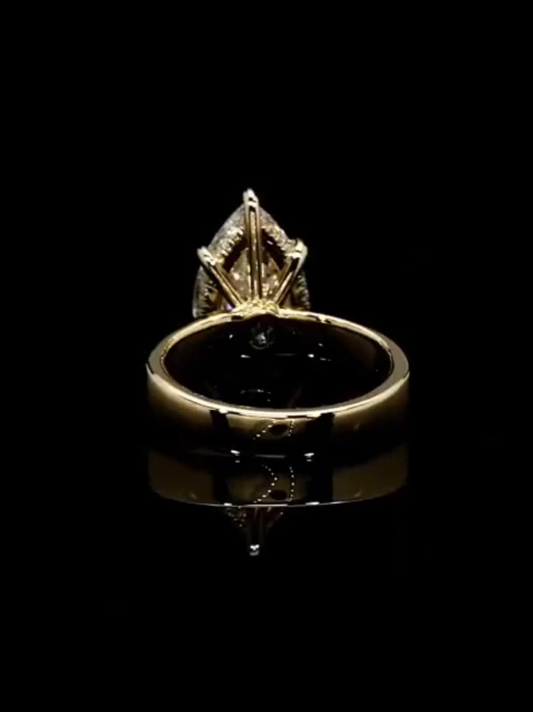 Rear perspective view showcasing the hidden halo diamond setting and solid yellow gold wide band.