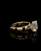 Side profile view of a 3 carat round lab grown diamond ring with hidden halo and side-edge pavé band in 18k yellow gold.