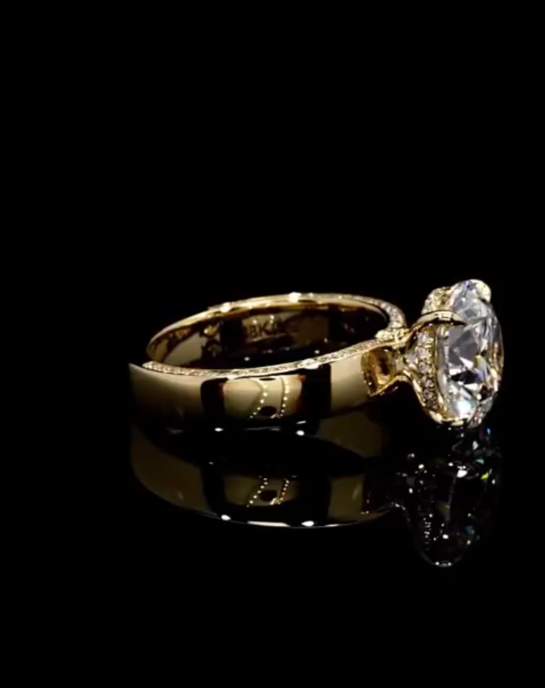 Side profile view of a 3 carat round lab grown diamond ring with hidden halo and side-edge pavé band in 18k yellow gold.