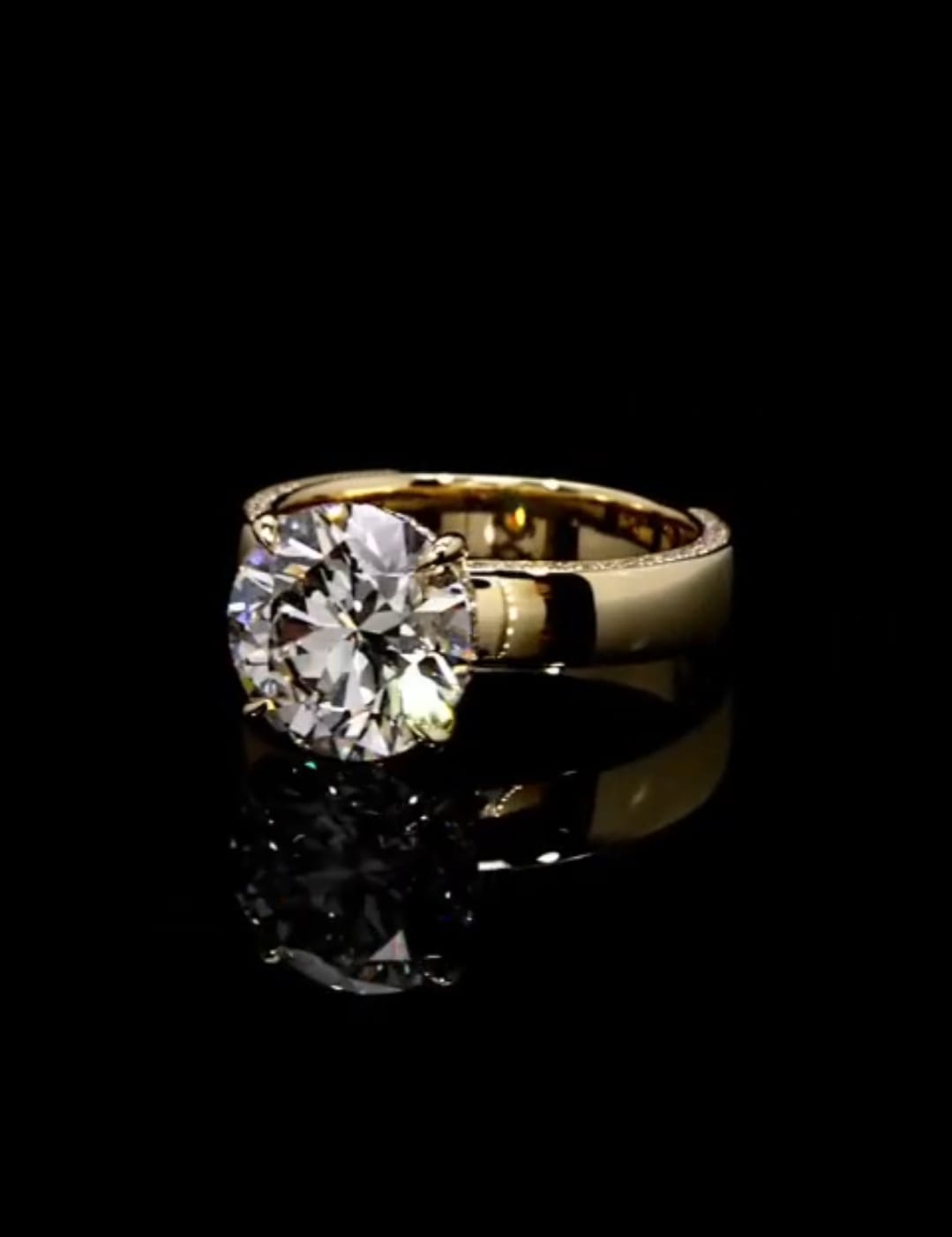 Angled front view displaying a 3 carat round brilliant lab created diamond set on a wide gold band.