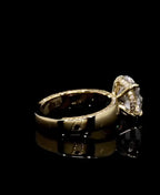 Elevated side profile view of a round diamond engagement ring showcasing the hidden halo setting.