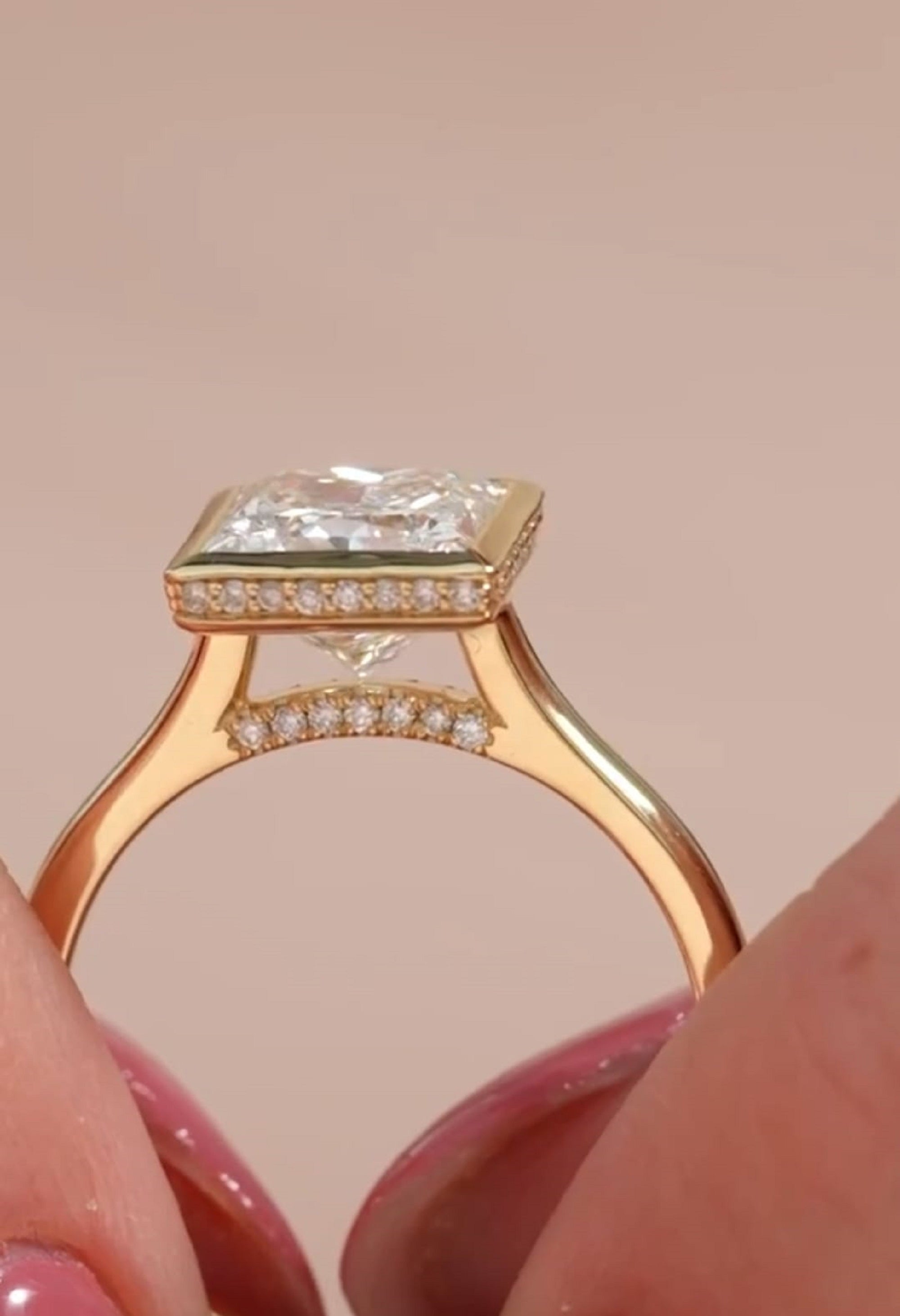 Side profile view showing the hidden halo collar and delicate pavé bridge accent on a 3 CT princess cut bezel ring.