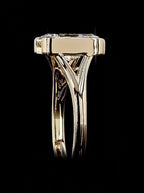 Detailed profile view showing the architectural cathedral split-shank structure of the gold bezel ring