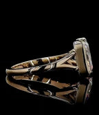 Profile view showing the comfortable low-profile bezel setting and split shank with a reflective black background