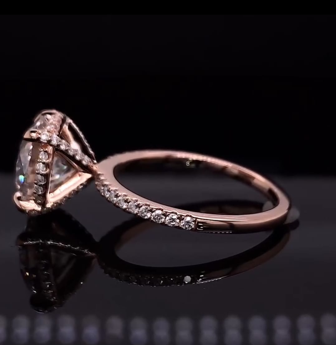 Full side elevation view showing the delicate rose gold pave band and hidden halo basket structure