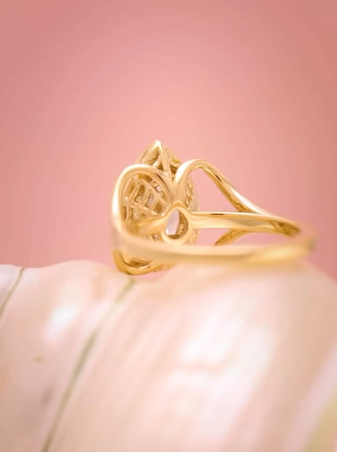 Detailed angled shot of the filigree under-basket and split band architecture of a 3ct pear diamond ring