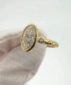 Angled shot of a 4 CT oval lab diamond ring featuring milgrain bezel edging and a side diamond accent