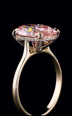Detailed profile shot showing the diamond hidden halo basket and claw prongs holding a 3ct pink oval lab diamond