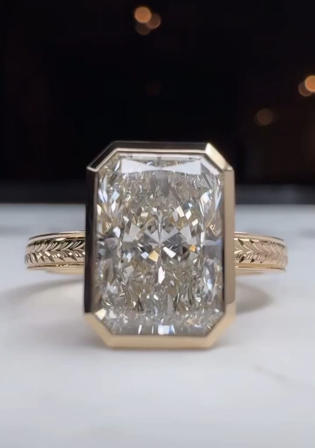 Direct face-up view of a brilliant 5 carat radiant cut lab created diamond in a full bezel setting