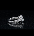 Side profile of a 3 carat round lab grown diamond engagement ring with hand-engraved filigree scrollwork in white gold