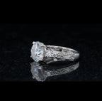 Detailed profile view highlighting milgrain edging and hand-carved scroll engraving on a white gold diamond ring