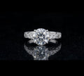 Direct top-down face view of a brilliant 3 carat round lab grown diamond in a vintage engraved white gold ring setting