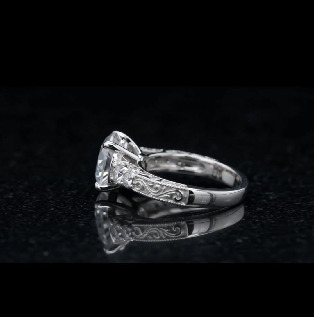 Side view of a 3 CT round lab grown diamond ring with filigree scroll engraving reflected on a black surface