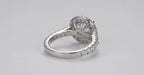 Side profile of a white gold halo engagement ring featuring a pave diamond band and solid polished bottom shank