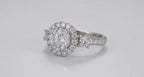 Three-quarter top perspective of a 3 carat round lab grown diamond ring with halo frame and side diamond accents