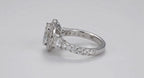 Side profile shot highlighting the prong set round side accent diamond on a pave white gold engagement ring