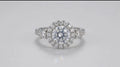 Direct top-down face view of a brilliant 3 carat round cut lab created diamond in a round halo ring setting