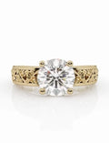 Front view of a 3 CT round brilliant cut lab-grown diamond engagement ring set in a yellow gold vintage band with detailed filigree scrollwork engraving.