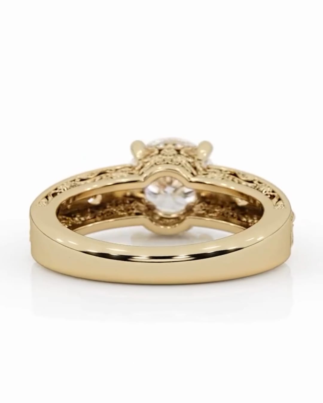 Bottom view of the vintage yellow gold diamond ring, showing the polished inner band transitioning into the engraved outer scrollwork.