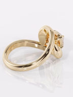 Back angle view highlighting the smooth, high-polish yellow gold contour band of a modern engagement ring