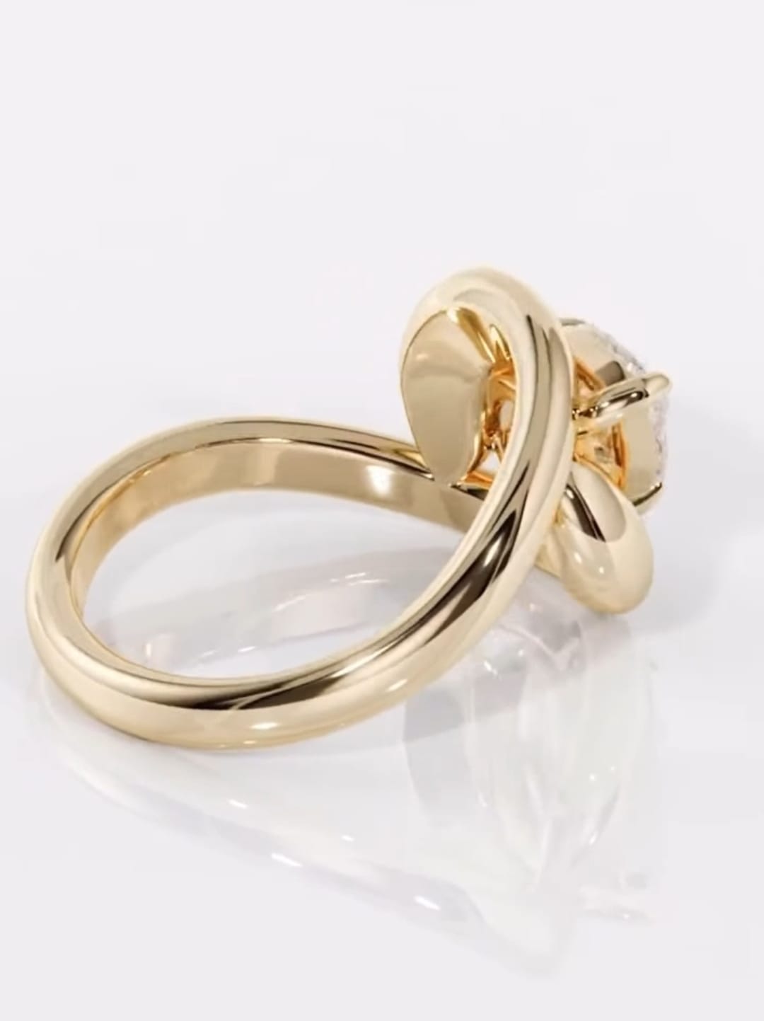 Back angle view highlighting the smooth, high-polish yellow gold contour band of a modern engagement ring