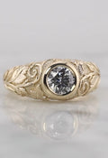 Top-down face-up view of a brilliant 2 carat round lab grown diamond set in a smooth yellow gold bezel