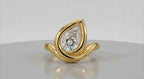 Top view of a stunning 3 CT pear-cut lab grown diamond in a modern yellow gold bypass bezel setting